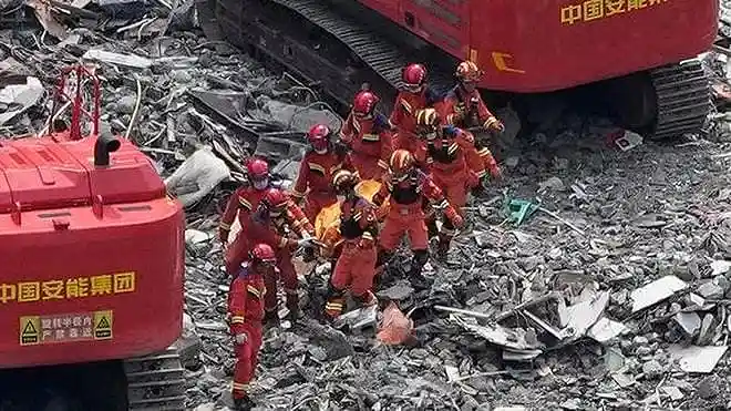 Rescuers work at the site of a deadly landslide in Pengshui County, Chongqing, southwestern China, where 51 people were killed and 10 remain missing