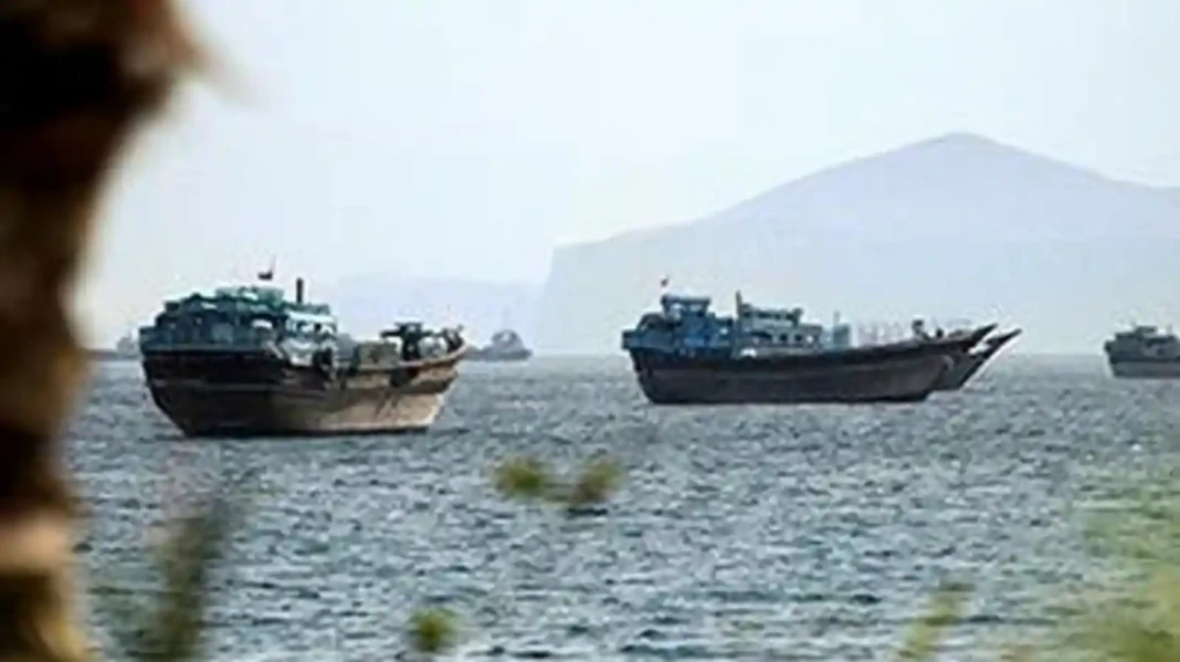 Cargo ships passing through the Strait of Hormuz amid rising tensions between Iran and the United States
