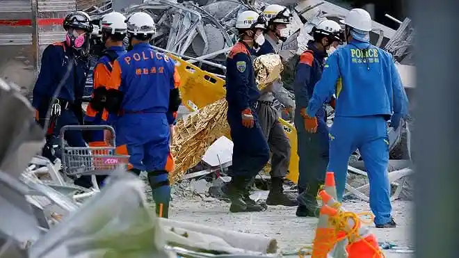 Rescue workers search the damaged Aeon Mall after a magnitude 7.1 earthquake in Kumamoto, Japan.