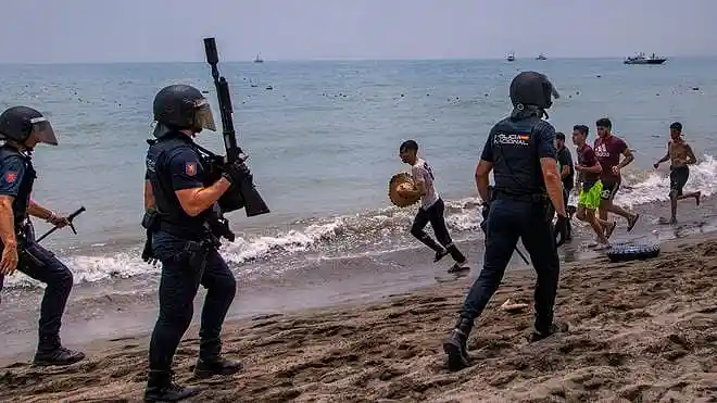 Migrants gather near the Morocco-Spain border as security forces respond after thousands attempted to enter the Spanish enclave of Ceuta