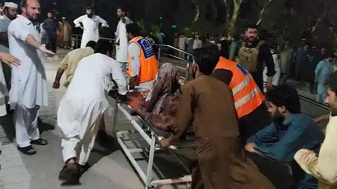 Rescue workers and volunteers carry an injured victim to a hospital after a suicide bombing in Bannu, Khyber Pakhtunkhwa, Pakistan, on July 15, 2026.