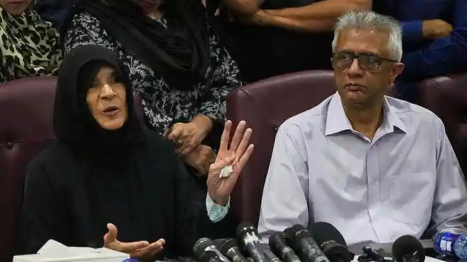 Former Pakistani Prime Minister Imran Khan's sister Uzma Khan speaks as his personal physician Faisal Sultan watches during a press conference in Islamabad on August 21, 2026.