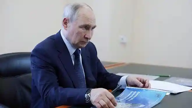 Russian President Vladimir Putin meets Sakhalin Governor Valery Limarenko during his visit to Iturup Island in the Southern Kuril Islands.
