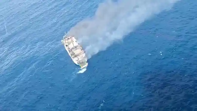 Aerial view of thick smoke rising from KM Putri Yasmin ferry after it caught fire off Lombok, Indonesia