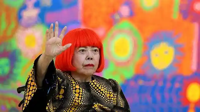 Japanese avant-garde artist Yayoi Kusama posing for a portrait