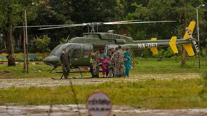 Survivors rescued from flash flooding are transported to safety by army helicopters in Nuwakot, Nepal, on August 29, 2026.