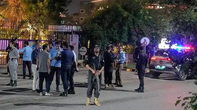 Police officers stand outside Shifa International Hospital in Islamabad during Imran Khan's court-ordered medical examination.