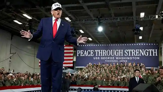 U.S. President Donald Trump gestures aboard the aircraft carrier USS George Washington during a visit to the U.S. Navy’s Yokosuka base in Yokosuka, Japan.